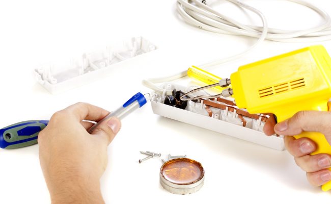 Hands repairing extension cord